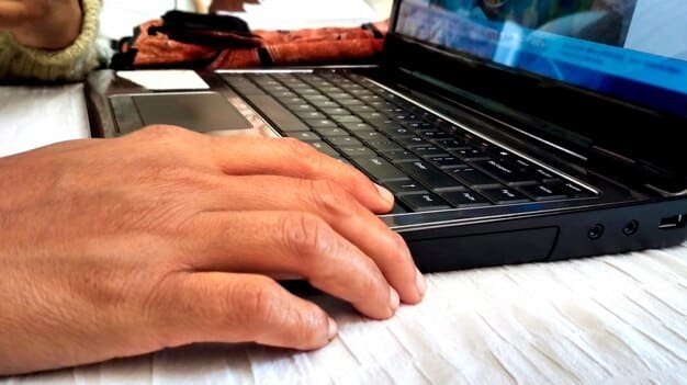 A close-up of hands typing on a laptop keyboard, with multiple screens blurred in the background displaying complex data and code, highlighting the importance of digital skills in the modern gig economy.
