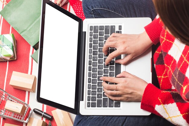 A person using a laptop to create a compelling social media ad for their holiday side hustle, showcasing the ease and effectiveness of online marketing.