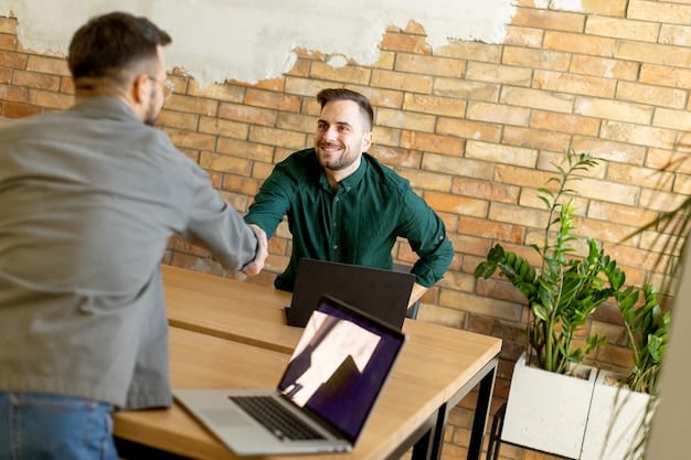 A freelancer and a client shaking hands after a successful negotiation. Both are smiling and appear satisfied with the outcome. The background is a modern office space.