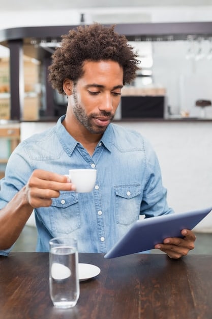 A freelancer smiling and confidently reviewing financial graphs on a tablet, with a cup of coffee and a plant on the desk. The scene is relaxed and productive, indicating financial stability and control.