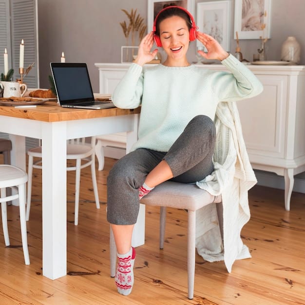 A freelancer wearing noise-canceling headphones, working on a laptop in a minimalistic and organized home office. Sunlight streams in through a nearby window, and there is a plant on the desk. The setting emphasizes a calm, distraction-free workspace.
