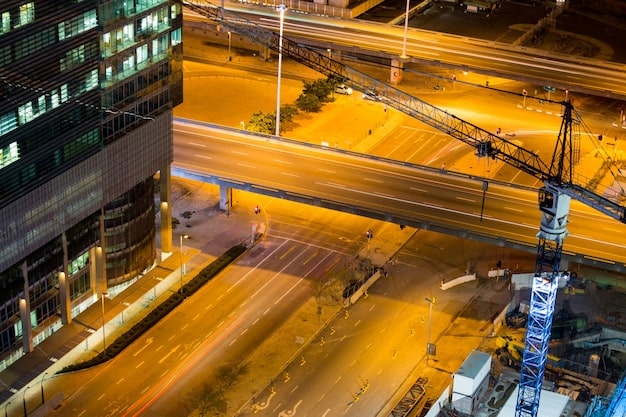 A time-lapse image of a busy construction site transforming into a completed, modern bridge or highway section, symbolizing progress and infrastructure development.
